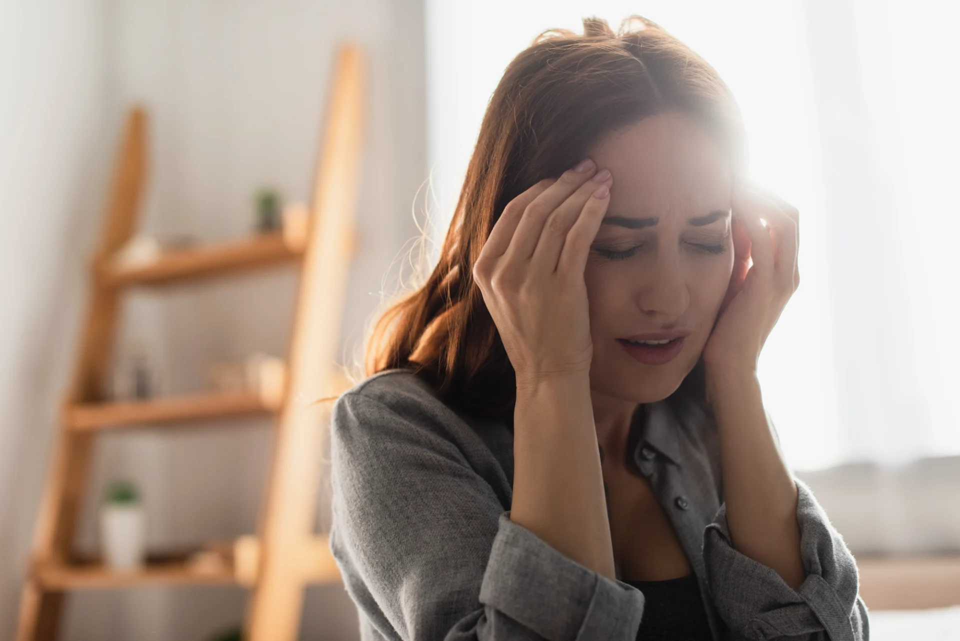 close up of a young woman with a migraine